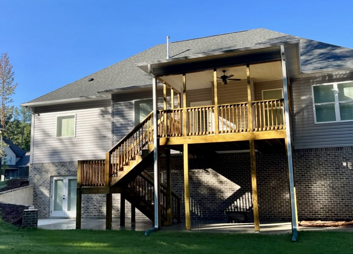 Two-story home exterior with a raised backyard deck