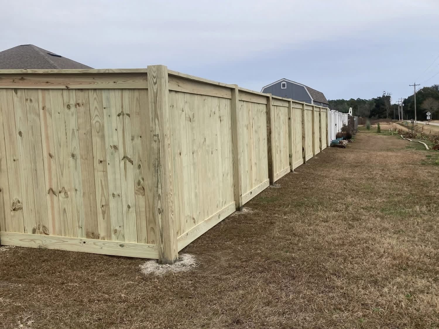 Cedar privacy fence running the length of a backyard