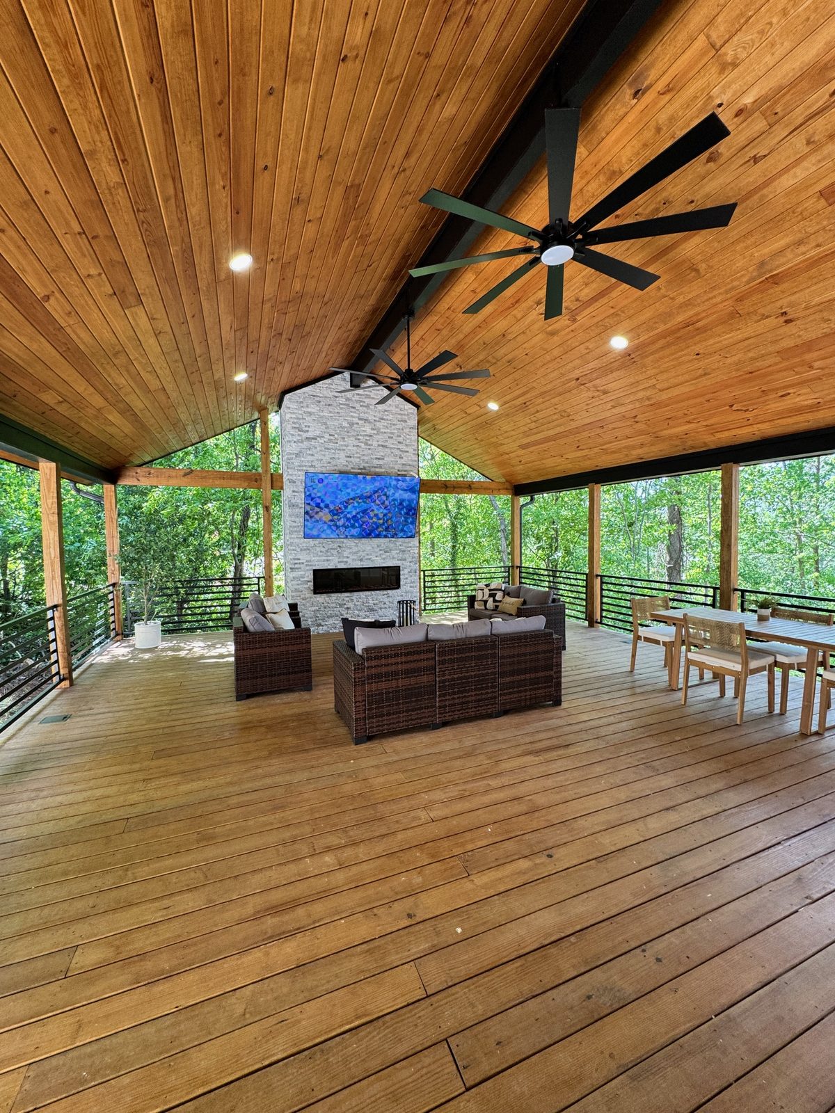 Vaulted great room with a wood ceiling and large fan