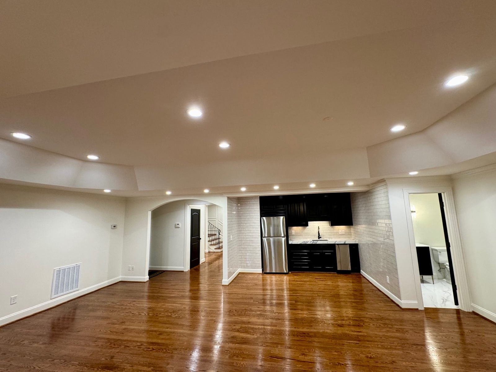 Open great room with hardwood floors leading to the kitchen