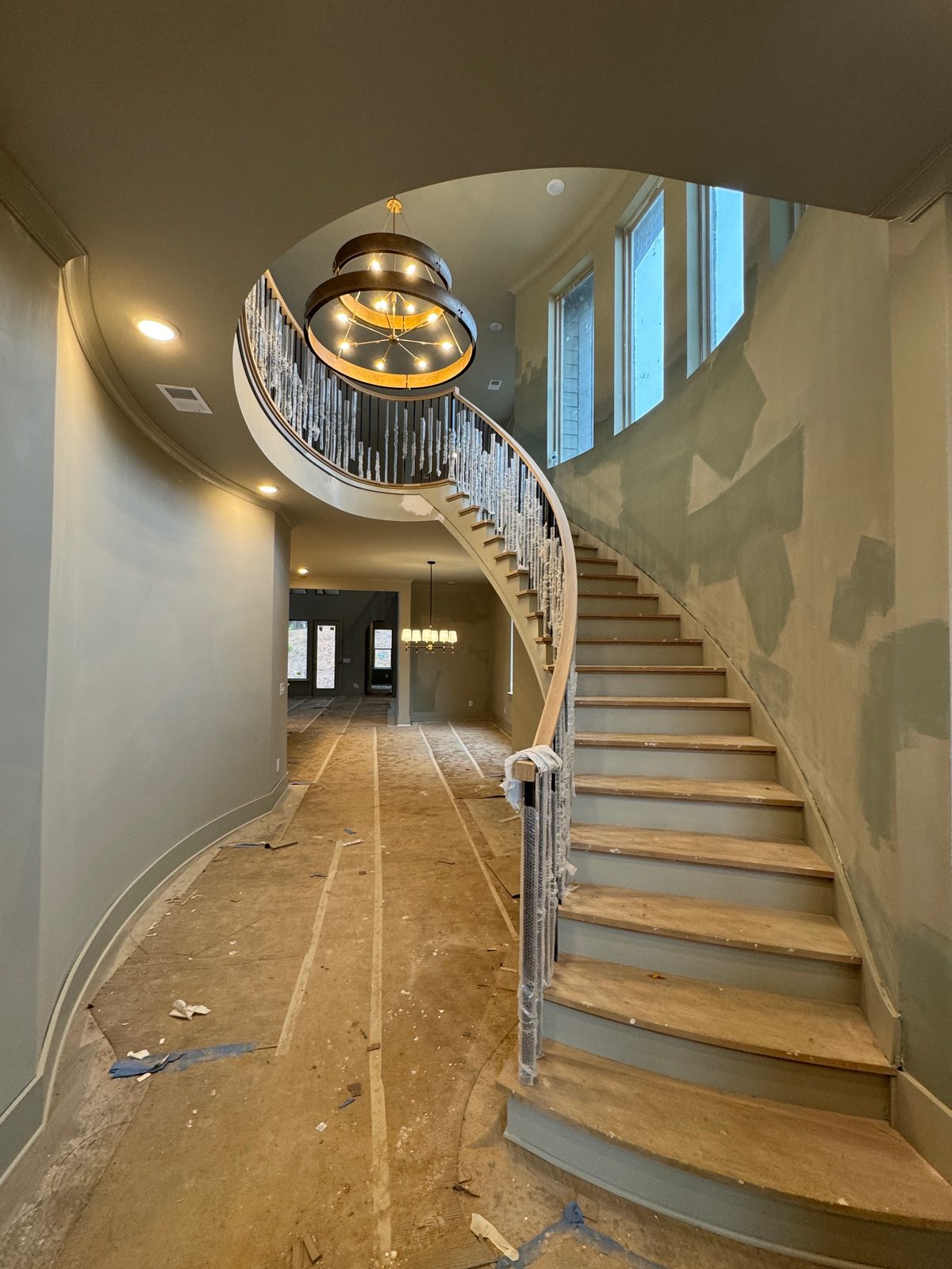 Curved staircase in a custom home under finish