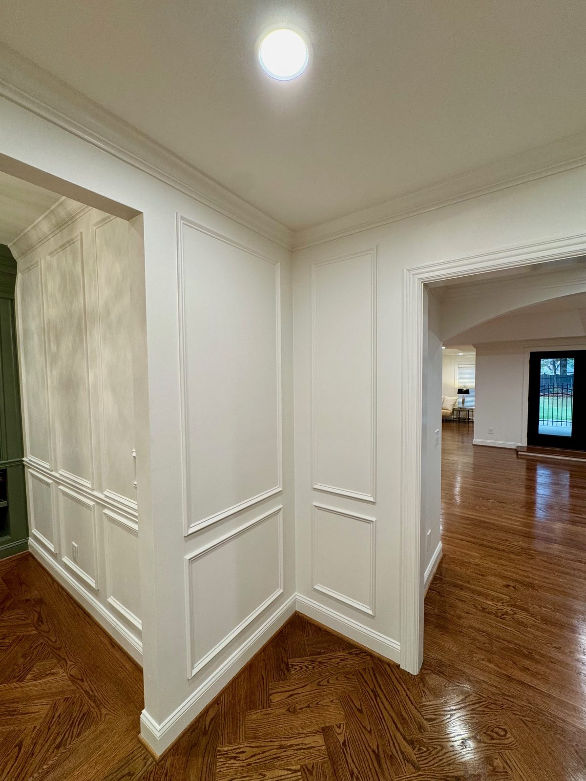 Freshly painted hallway with custom wainscoting and trim
