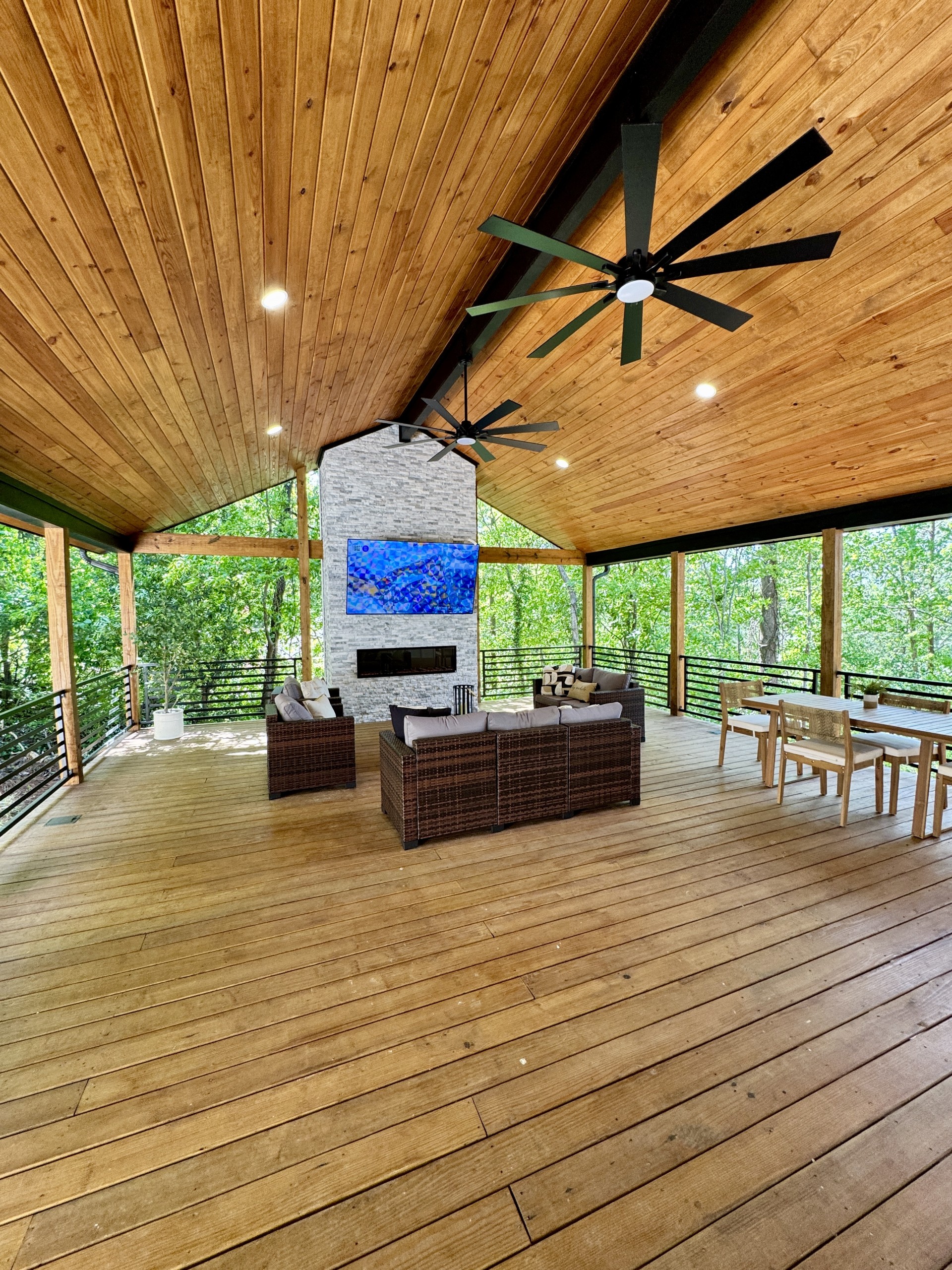 Vaulted outdoor deck with wood ceiling and stone fireplace, Vestavia Hills, by CB Built Homes