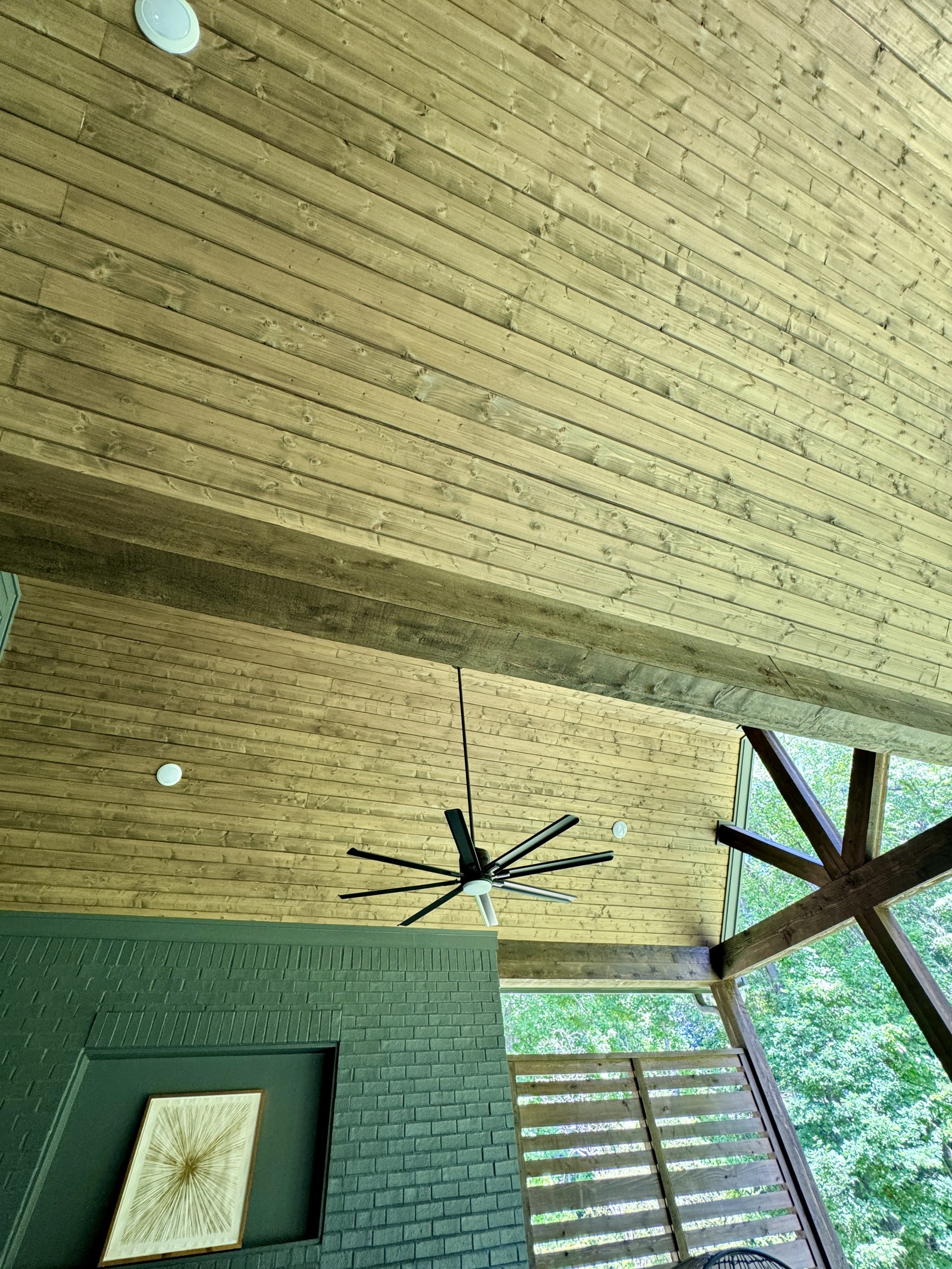 Vaulted wood porch ceiling with a ceiling fan, by CB Built Homes
